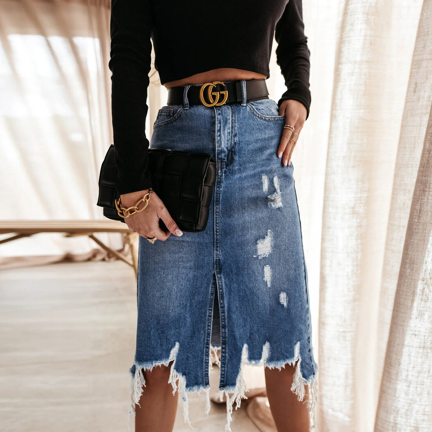 Irregular Holes In A Fringed Denim Skirt