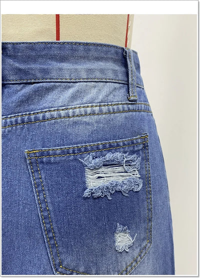 Irregular Holes In A Fringed Denim Skirt