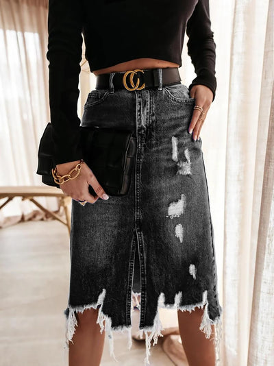 Irregular Holes In A Fringed Denim Skirt